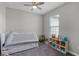 bedroom with a bed, shelving unit with toys and a ceiling fan at 1391 Shinnecock Hills Dr, Davenport, FL 33896