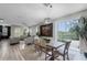 Open-concept space features a spacious dining area with large windows and stylish furniture at 1391 Shinnecock Hills Dr, Davenport, FL 33896