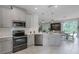Modern kitchen features stainless steel appliances, ample counter space, and stylish gray cabinets at 1391 Shinnecock Hills Dr, Davenport, FL 33896
