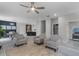 Spacious living area seamlessly connects the living room, dining area, and kitchen with gray wood floors at 1391 Shinnecock Hills Dr, Davenport, FL 33896