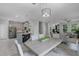 Open floor plan with view of kitchen, dining area and living room with modern light fixtures at 1391 Shinnecock Hills Dr, Davenport, FL 33896
