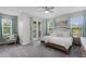 Comfortable main bedroom with a ceiling fan, balcony, and abundant natural light at 1391 Shinnecock Hills Dr, Davenport, FL 33896