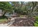 Backyard featuring mature trees and privacy fence near screened in pool at 1425 Mt Laurel Dr, Winter Springs, FL 32708
