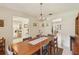 Bright dining room with a modern chandelier and a glimpse of the living area at 1425 Mt Laurel Dr, Winter Springs, FL 32708