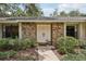 Close-up of a classic brick facade and bright double doors at 1425 Mt Laurel Dr, Winter Springs, FL 32708