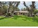Charming single-story home with a lush green lawn and mature trees at 1425 Mt Laurel Dr, Winter Springs, FL 32708