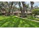 Charming home with a lush front yard, mature trees, and inviting walkway at 1425 Mt Laurel Dr, Winter Springs, FL 32708
