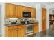 Close up of the stainless steel oven and cooktop and dark granite countertops at 1425 Mt Laurel Dr, Winter Springs, FL 32708