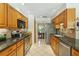 Traditional kitchen with wooden cabinets, stainless steel appliances, and black granite countertops at 1425 Mt Laurel Dr, Winter Springs, FL 32708