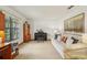 Bright living room with piano, large window, and comfortable seating at 1425 Mt Laurel Dr, Winter Springs, FL 32708