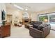 Cozy living room with brick fireplace, leather furniture, and view of the pool at 1425 Mt Laurel Dr, Winter Springs, FL 32708