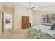 Another view of the bright main bedroom with an armoire and ceiling fan at 1425 Mt Laurel Dr, Winter Springs, FL 32708