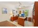Office space with built-in shelves, ceiling fan, and a window for natural light at 1425 Mt Laurel Dr, Winter Springs, FL 32708
