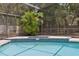 Swimming pool featuring a tile-lined edge and a lush tropical garden at 1425 Mt Laurel Dr, Winter Springs, FL 32708