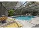 Gorgeous pool area featuring a screened enclosure and lush tropical landscaping at 1425 Mt Laurel Dr, Winter Springs, FL 32708