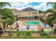 A stunning aerial view of the backyard oasis featuring a pool, spa, outdoor kitchen, and manicured landscaping at 14744 Spotted Sandpiper Blvd, Winter Garden, FL 34787