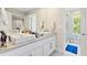 Modern bathroom with double sinks, granite countertops, and a glass-enclosed shower at 14744 Spotted Sandpiper Blvd, Winter Garden, FL 34787