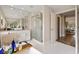 An elegant bathroom offers a shower with glass doors and a soaking tub with a vanity at 14744 Spotted Sandpiper Blvd, Winter Garden, FL 34787