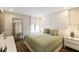 Bright bedroom with dark hardwood floors and white paneled accent wall behind the king bed at 14744 Spotted Sandpiper Blvd, Winter Garden, FL 34787