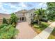 Beautiful two-story home with a well-manicured lawn, lush landscaping, and a welcoming front porch at 14744 Spotted Sandpiper Blvd, Winter Garden, FL 34787