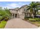 Charming two-story home featuring a manicured lawn, paved driveway, and attached two car garage at 14744 Spotted Sandpiper Blvd, Winter Garden, FL 34787