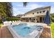 Exterior view showcases a hot tub with backyard, outdoor kitchen, and manicured landscaping at 14744 Spotted Sandpiper Blvd, Winter Garden, FL 34787