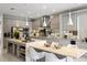 Bright kitchen with modern white cabinetry, stainless steel appliances, and a large center island at 14744 Spotted Sandpiper Blvd, Winter Garden, FL 34787