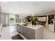 Bright living space with large kitchen island, an entertainment area, and access to the pool at 14744 Spotted Sandpiper Blvd, Winter Garden, FL 34787