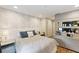 A comfortable bedroom showcases stylish wall accents and a dedicated storage area with display shelving at 14744 Spotted Sandpiper Blvd, Winter Garden, FL 34787