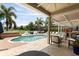 A luxurious outdoor oasis with a pool, spa, lush landscaping, and comfortable seating for relaxation and entertainment at 14744 Spotted Sandpiper Blvd, Winter Garden, FL 34787