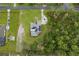 Aerial view of property showing pool, solar panels, and proximity to wooded area at 15038 Willow Ln, Tavares, FL 32778