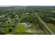 Panoramic aerial shot of property set within a landscape of lush, mature trees at 15038 Willow Ln, Tavares, FL 32778