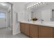 Bathroom featuring a double vanity with sink, a glass enclosed shower and tiled flooring at 15038 Willow Ln, Tavares, FL 32778