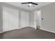 Neutral bedroom with three large closets, ceiling fan and carpet flooring at 15038 Willow Ln, Tavares, FL 32778