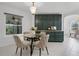 Bright breakfast nook features a glass table, seating for four, and custom storage cabinets at 15038 Willow Ln, Tavares, FL 32778