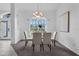 Bright dining room with elegant chandelier, table set for four, and large windows offering natural light at 15038 Willow Ln, Tavares, FL 32778