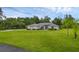 Beautiful single-story home with lush green lawn and mature trees at 15038 Willow Ln, Tavares, FL 32778
