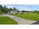 Charming single-story home with manicured front lawn and long driveway at 15038 Willow Ln, Tavares, FL 32778