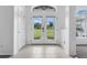 Bright foyer with double-door entry, tiled floors, and a view of the landscaped front yard at 15038 Willow Ln, Tavares, FL 32778