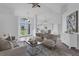 Inviting living room with neutral tones, stylish furnishings, and a view of the front yard at 15038 Willow Ln, Tavares, FL 32778
