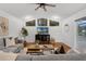 Cozy living room with hardwood floors, vaulted ceilings, and sliding glass doors to the outdoor pool area at 15038 Willow Ln, Tavares, FL 32778