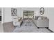 Comfortable living room featuring neutral furnishings, modern décor, and sliding glass doors leading to the pool at 15038 Willow Ln, Tavares, FL 32778