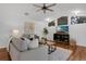 Comfortable living room with hardwood floors, vaulted ceilings, modern decor, and an adjacent sunroom at 15038 Willow Ln, Tavares, FL 32778