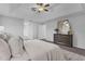 This cozy main bedroom is carpeted and features a dresser and large bed with nightstands at 15038 Willow Ln, Tavares, FL 32778