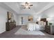 Spacious main bedroom featuring a tray ceiling, ceiling fan, and access to the lanai at 15038 Willow Ln, Tavares, FL 32778