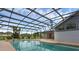 View of the screened-in pool and lanai from the shallow end at 15038 Willow Ln, Tavares, FL 32778