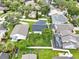 Expansive aerial view of a well-maintained home featuring a screened-in pool and fenced yard at 1706 Terra Cota Ct, Orlando, FL 32825