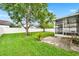 Spacious backyard featuring a screened lanai, lush lawn, mature trees, and a privacy fence at 1706 Terra Cota Ct, Orlando, FL 32825