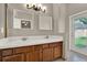 Double vanity bathroom with tile countertops and an exit to the backyard at 1706 Terra Cota Ct, Orlando, FL 32825