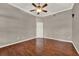 A spacious room featuring hardwood floors, a ceiling fan, and neutral paint at 1706 Terra Cota Ct, Orlando, FL 32825